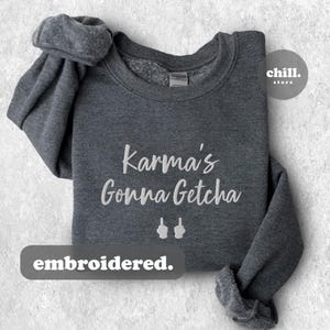 May include: Gray sweatshirt with the text "Karma's Gonna Getcha" embroidered in white with two white middle fingers pointing up.