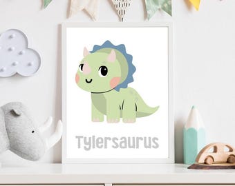 May include: A white framed print with a green and blue cartoon triceratops with the text "Tylersaurus" below.