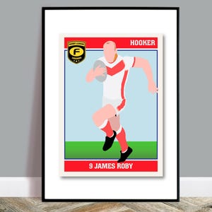 May include: Framed print featuring a stylized illustration of a rugby player in a red and white uniform, holding a ball. The print includes the text "HOOKER" and "9 JAMES ROBY" on a red background, with a green and blue field.