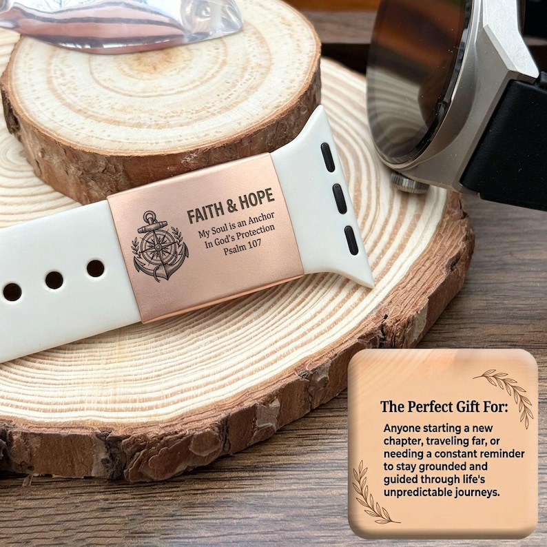 May include: A white silicone watch band featuring a rose gold metal charm engraved with an anchor, a compass, and the text FAITH & HOPE, My Soul is an Anchor, In God's Protection, Psalm 107, alongside a square wooden card with printed text.