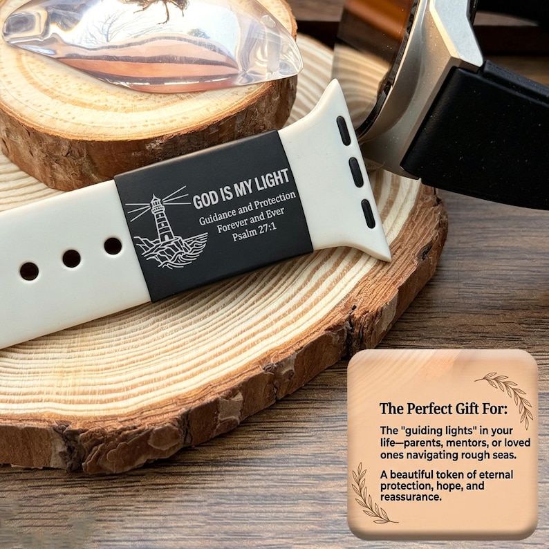 May include: A white silicone watch band featuring a black rectangular insert engraved with a lighthouse graphic and the text "GOD IS MY LIGHT Guidance and Protection Forever and Ever Psalm 27:1". The band has three circular adjustment holes.