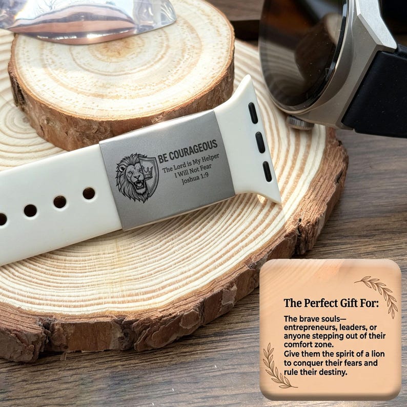 May include: A white silicone watch band featuring a metallic silver-toned slider engraved with a lion head, a shield, and the text BE COURAGEOUS, The Lord is My Helper, I Will Not Fear, Joshua 1:9, alongside a square card with printed text.
