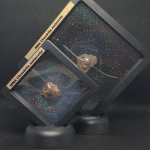 Genuine meteorite space rock in night sky effect holographic black display box art gift collectible with Certificate of Authenticity.