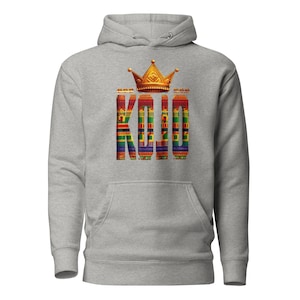 May include: A gray hooded sweatshirt with a gold crown and the word "KOJO" in colorful patterned letters.