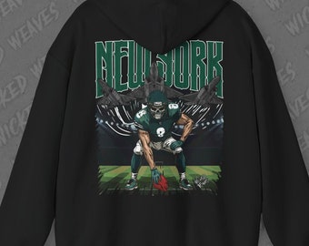 May include: Black hooded sweatshirt featuring a graphic print of a football player in a green and white uniform. The graphic also includes the text "NEW YORK" in white letters.