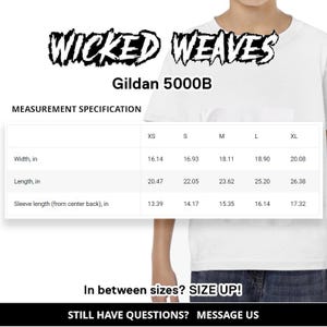 May include: A size chart for Gildan 5000B t-shirts, showing measurements in inches for width, length, and sleeve length from center back. Sizes include XS, S, M, L, and XL.