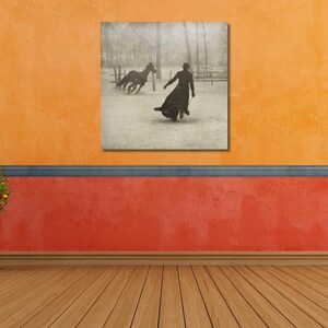 May include: A black and white photograph of a woman in a long coat walking away from two horses in a snowy field.