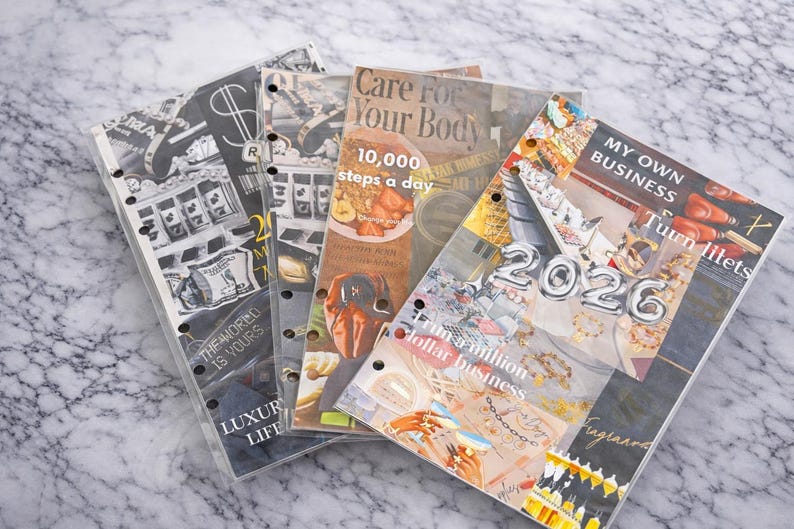 May include: A stack of planner inserts with various themes. One insert reads "Care for Your Body" with "10,000 steps a day." Another says "My Own Business" with "2026" in silver balloons. Other inserts have text like "Luxury Life."