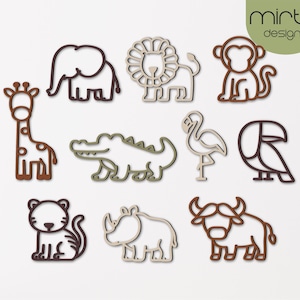 May include: A selection of wooden animal cutouts, featuring a giraffe, elephant, lion, monkey, crocodile, flamingo, toucan, tiger, rhino, and buffalo. The cutouts are in shades of brown, green, and beige, with a minimalist design. The "minta designs" logo is in the upper right corner.