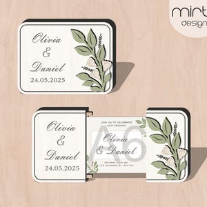 Peut inclure: Une invitation de mariage blanche avec un motif floral vert. L'invitation indique "Olivia & Daniel 24.05.2025".