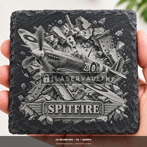 May include: A square black slate coaster featuring a laser-engraved image of a Supermarine Spitfire aircraft emerging from rubble. The design includes the text LASERVAULT and SPITFIRE on a metal-style plaque at the bottom with winged accents.