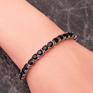 A handcrafted 925 sterling silver 5mm tennis bracelet featuring sparkling gemstone accents in a sleek prong setting.