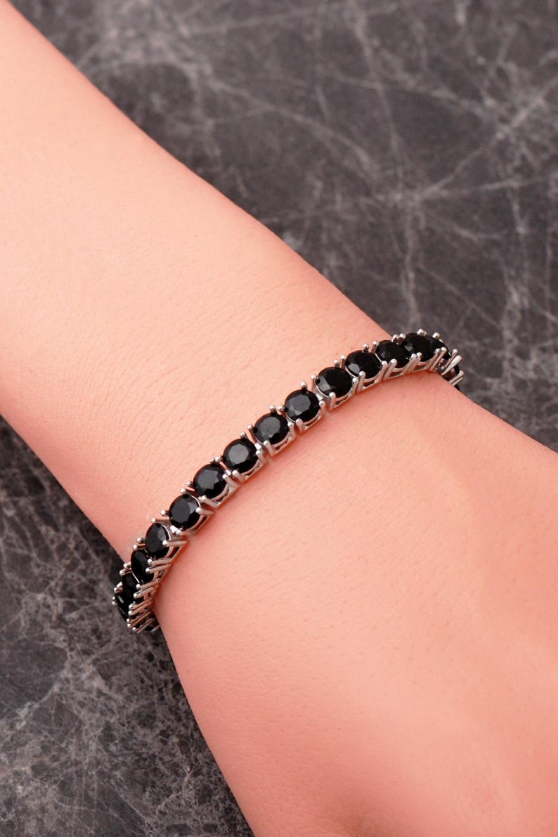 A handcrafted 925 sterling silver 5mm tennis bracelet featuring sparkling gemstone accents in a sleek prong setting.