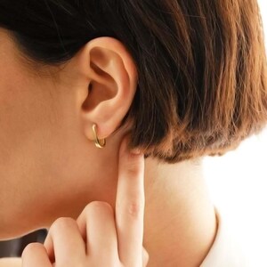 Handcrafted gold-plated 925 sterling silver oval hoop earrings with a smooth, polished finish and seamless closure.