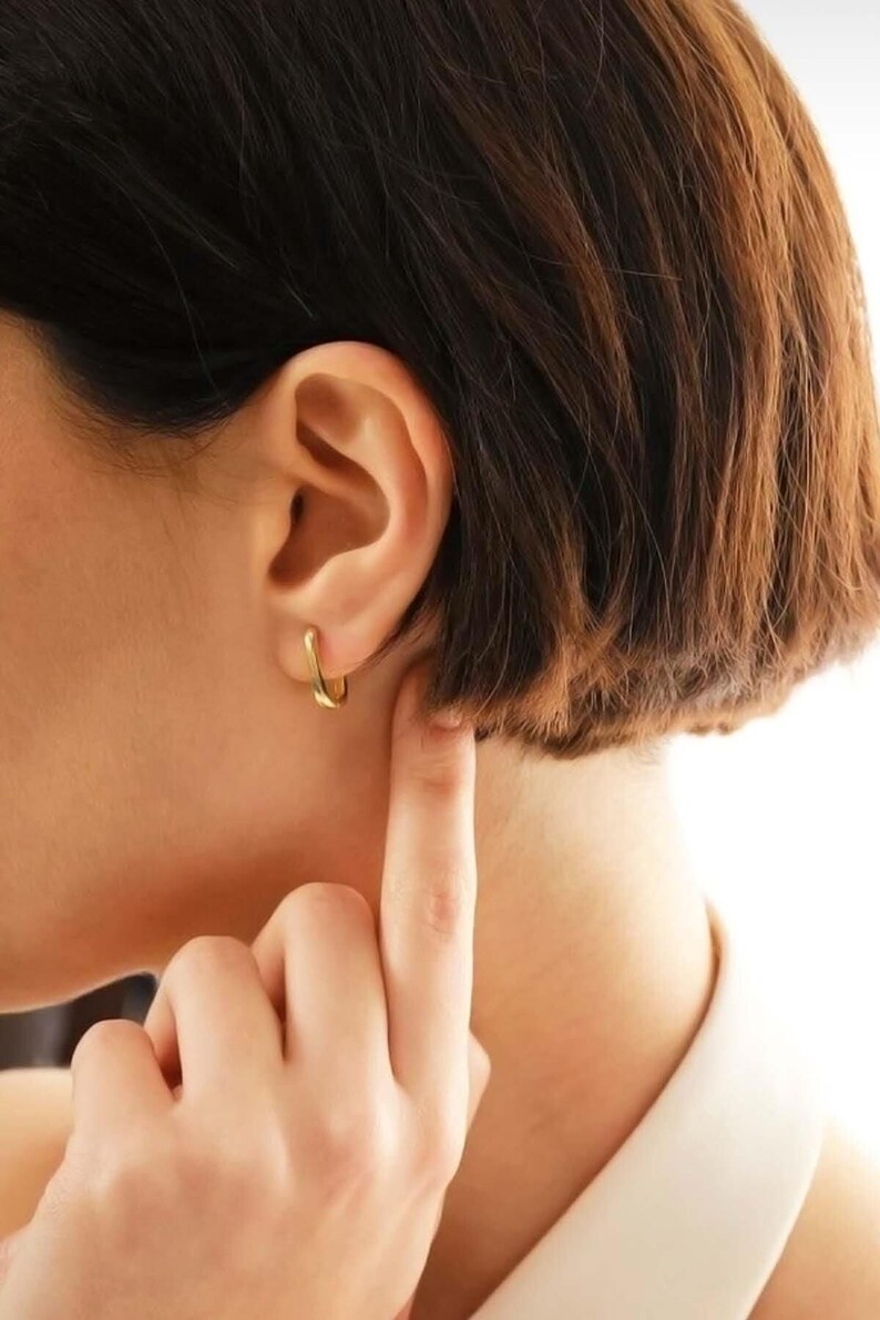 Handcrafted gold-plated 925 sterling silver oval hoop earrings with a smooth, polished finish and seamless closure.