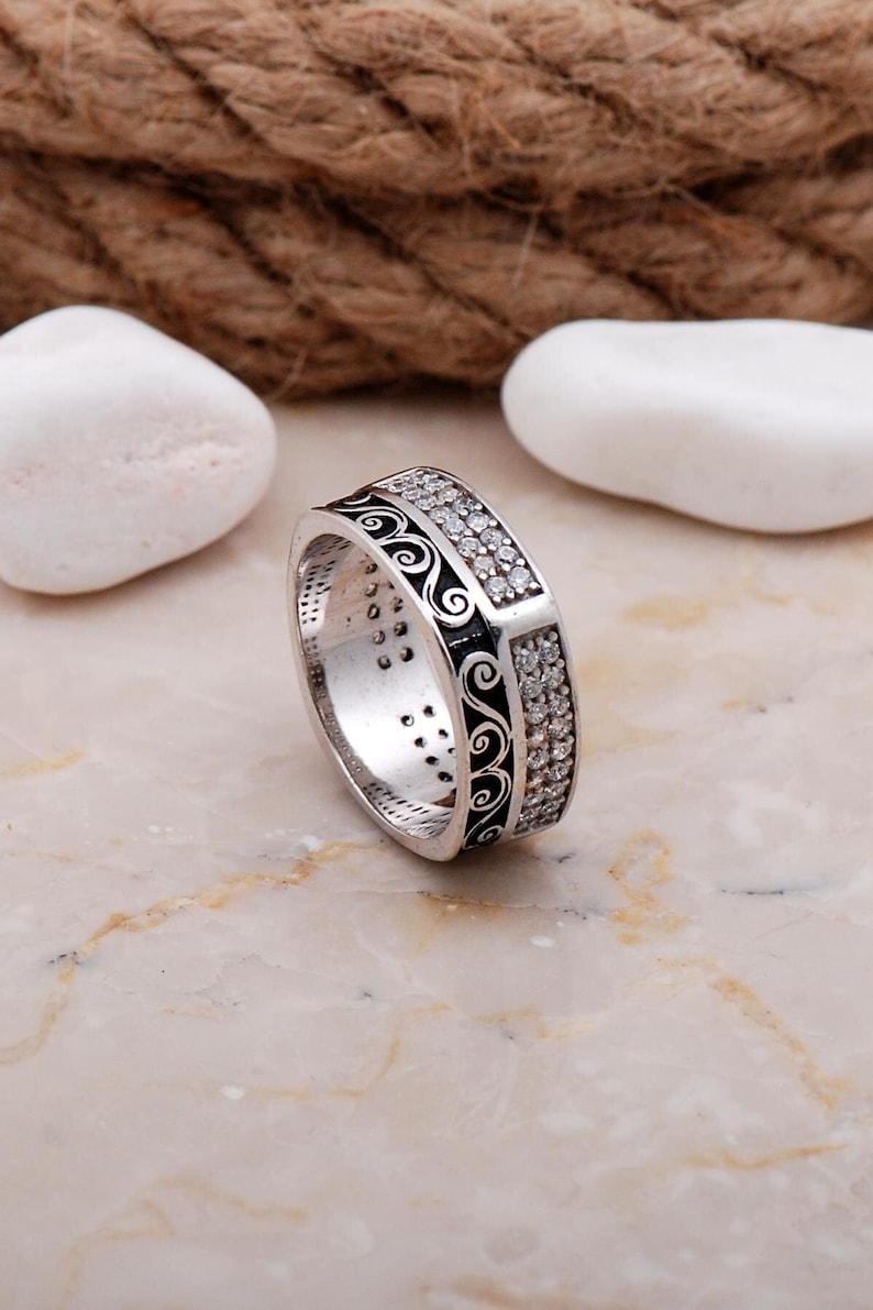 Handmade 7mm silver ring with white gold plating and sparkling cubic zirconia stones set in a delicate filigree design.