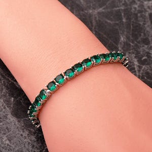 A handcrafted 925 sterling silver 5mm tennis bracelet featuring sparkling gemstone accents in a sleek prong setting.