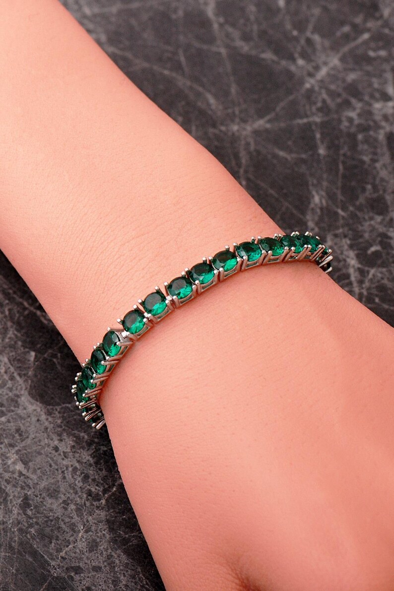 A handcrafted 925 sterling silver 5mm tennis bracelet featuring sparkling gemstone accents in a sleek prong setting.