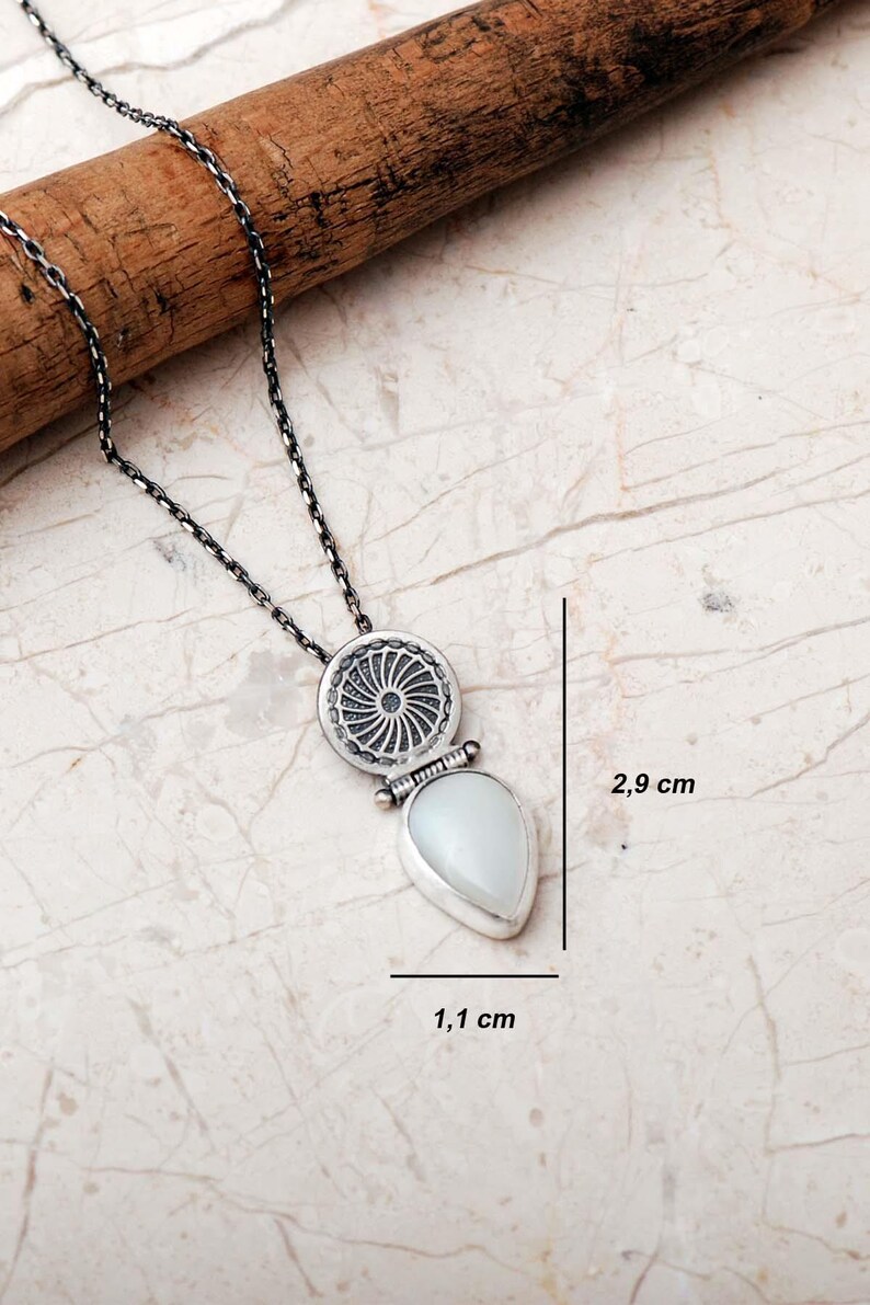 Handmade 925 sterling silver teardrop jewelry set featuring a mother of pearl pendant necklace and matching drop earrings adorned with intricate vintage motifs and an oxidized silver finish.