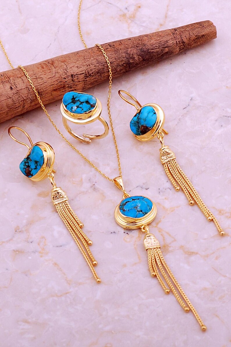 A handmade 925 sterling silver gold plated jewelry set featuring a woven tassel pendant necklace, dangling earrings, and an adjustable ring, all adorned with natural blue turquoise stones.