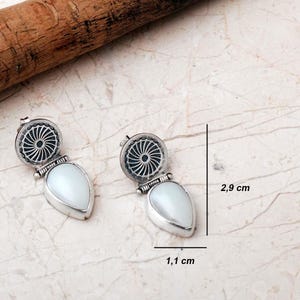 Handmade 925 sterling silver teardrop jewelry set featuring a mother of pearl pendant necklace and matching drop earrings adorned with intricate vintage motifs and an oxidized silver finish.