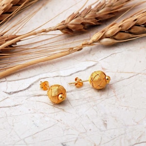 Handcrafted Kazaziye earrings made of 1000k sterling silver with a gold‑plated finish, featuring intricate woven wire knots and a small 8 mm diameter design.