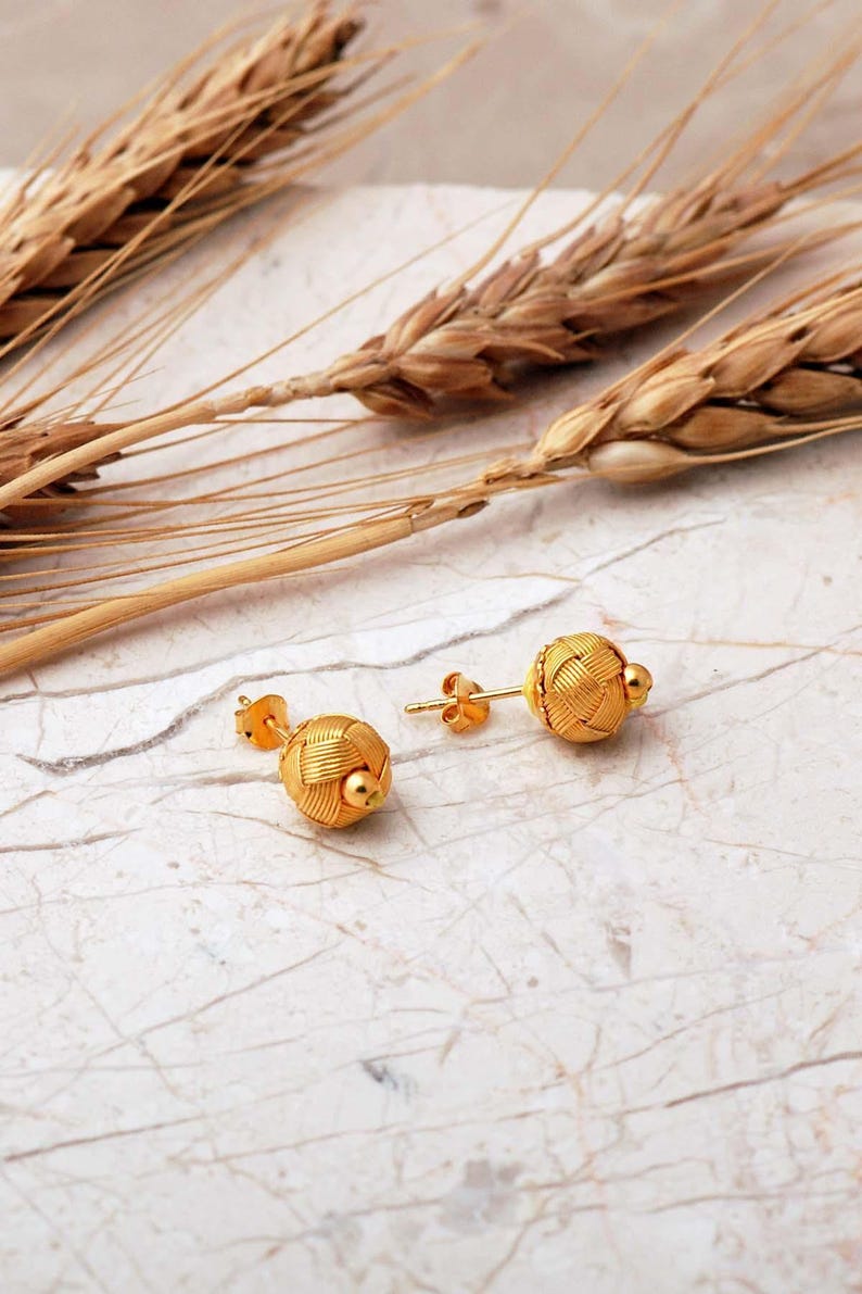 Handcrafted Kazaziye earrings made of 1000k sterling silver with a gold‑plated finish, featuring intricate woven wire knots and a small 8 mm diameter design.