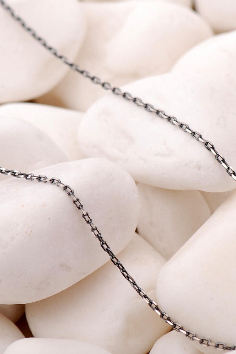 A 50 cm long blackened oxidized silver chain necklace with a sleek 1 mm thickness, displayed on a neutral background.