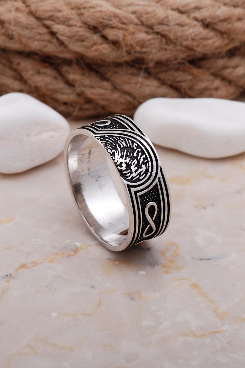 Handmade men's infinity love ring made of 925 sterling silver with a white gold plated finish, showing a smooth 9mm wide band.