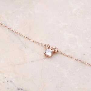 A rose‑gold plated hair coil made of 925 sterling silver, adorned with small cubic zirconia stones, measuring about 23 cm in length.