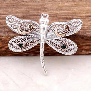 Sterling Silver Filigree Dragonfly Brooch with Bronze Accent and Green Gem Wings for Elegant Nature Inspired Vintage Look