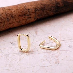 Handcrafted gold-plated 925 sterling silver oval hoop earrings with a smooth, polished finish and seamless closure.