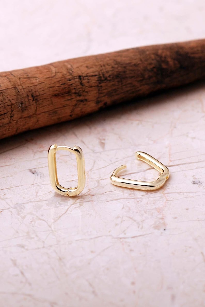 Handcrafted gold-plated 925 sterling silver oval hoop earrings with a smooth, polished finish and seamless closure.