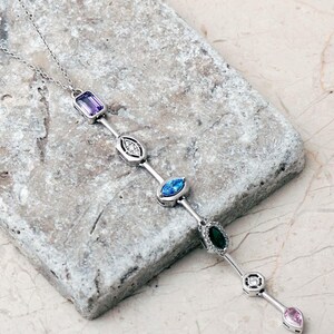 A handcrafted modern 925 sterling silver Y-shaped pendant necklace featuring a colorful vertical arrangement of geometric amethyst, jade, topaz, and zircon gemstones.