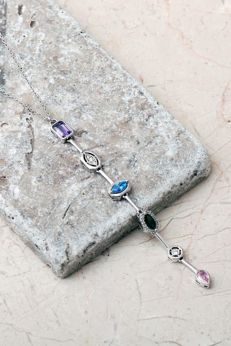 A handcrafted modern 925 sterling silver Y-shaped pendant necklace featuring a colorful vertical arrangement of geometric amethyst, jade, topaz, and zircon gemstones.