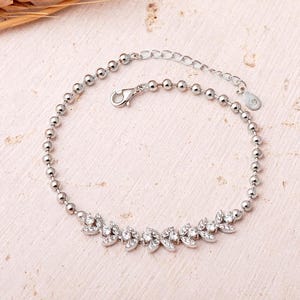 A rhodium‑plated 925 sterling silver bracelet with a wheat motif and sparkling clear zircon stones, measuring approximately 18 cm in length.