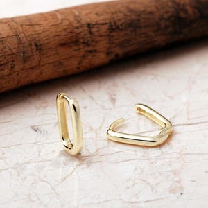 Handcrafted gold-plated 925 sterling silver oval hoop earrings with a smooth, polished finish and seamless closure.