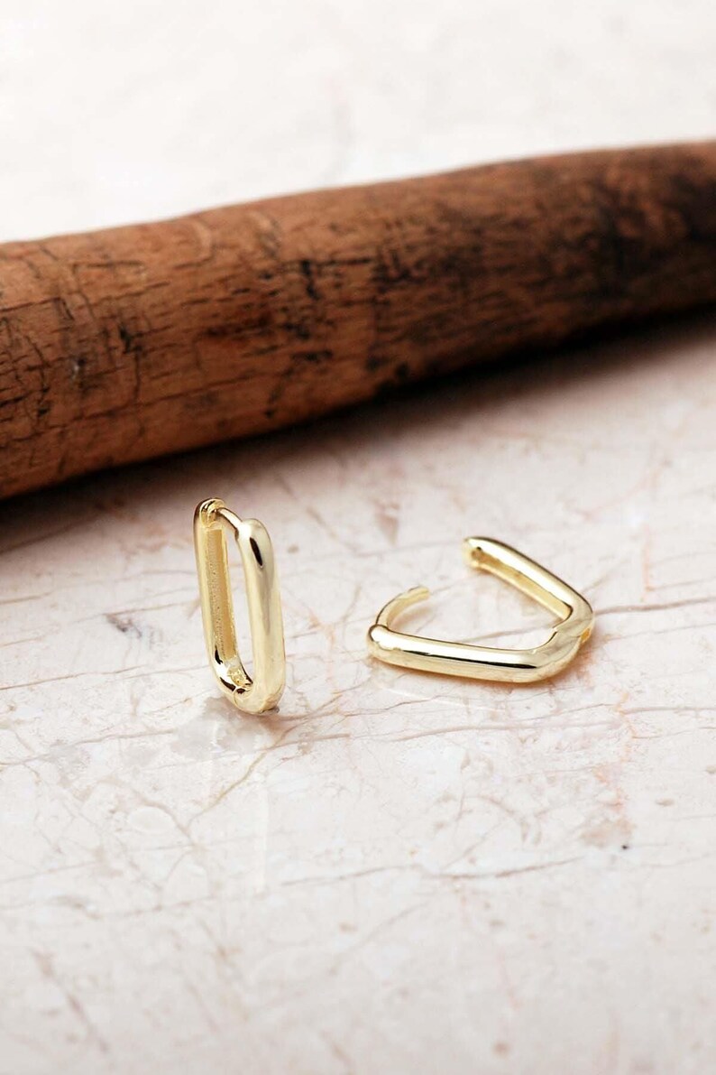 Handcrafted gold-plated 925 sterling silver oval hoop earrings with a smooth, polished finish and seamless closure.