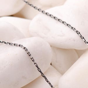 A 45 cm long blackened 925 sterling silver chain necklace with an oxidized finish displayed on a dark background.