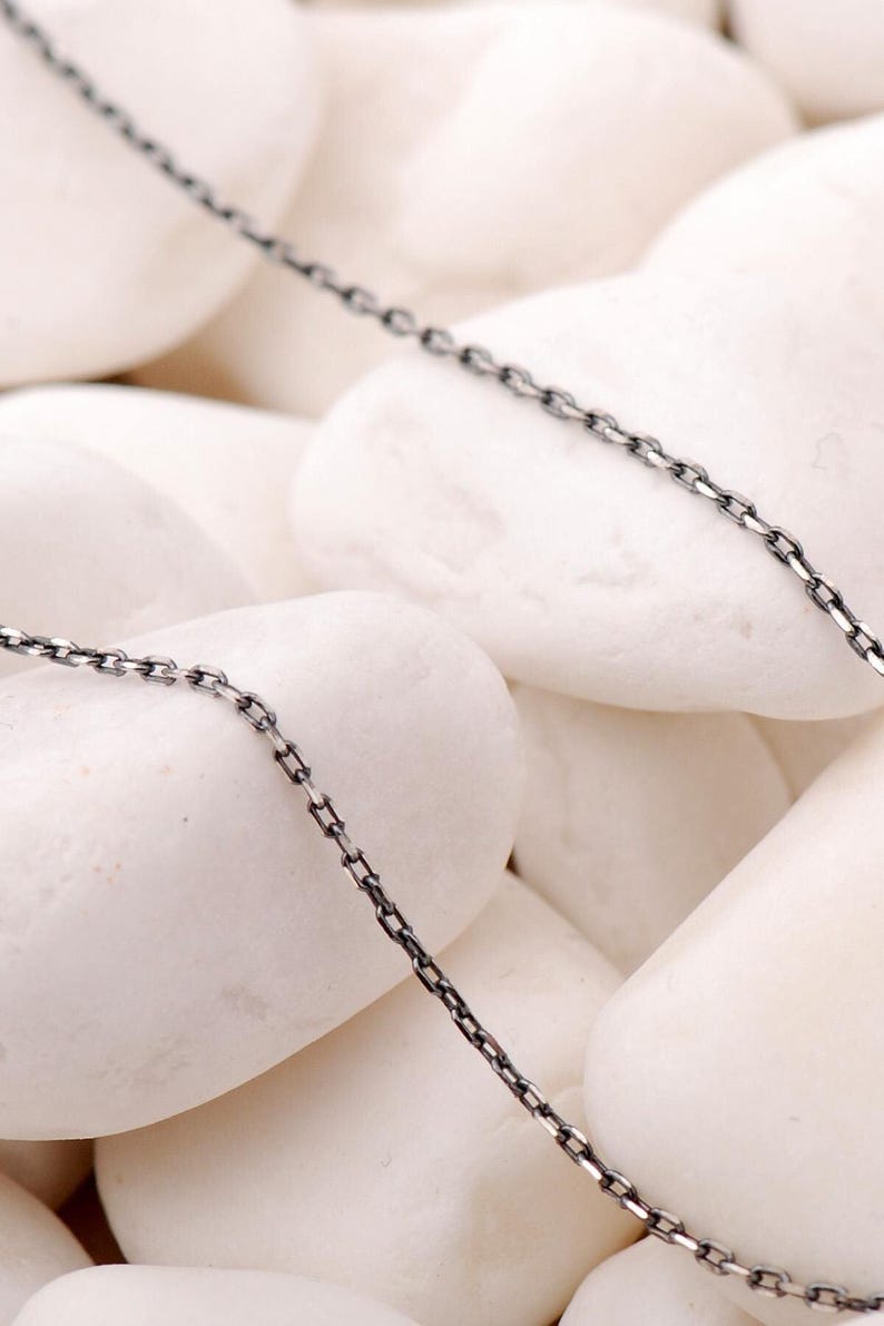A 45 cm long blackened 925 sterling silver chain necklace with an oxidized finish displayed on a dark background.