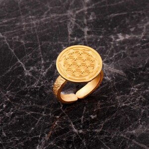 Handmade adjustable ring in 925 sterling silver with a green gold plated finish, featuring a detailed life flower motif on the band.