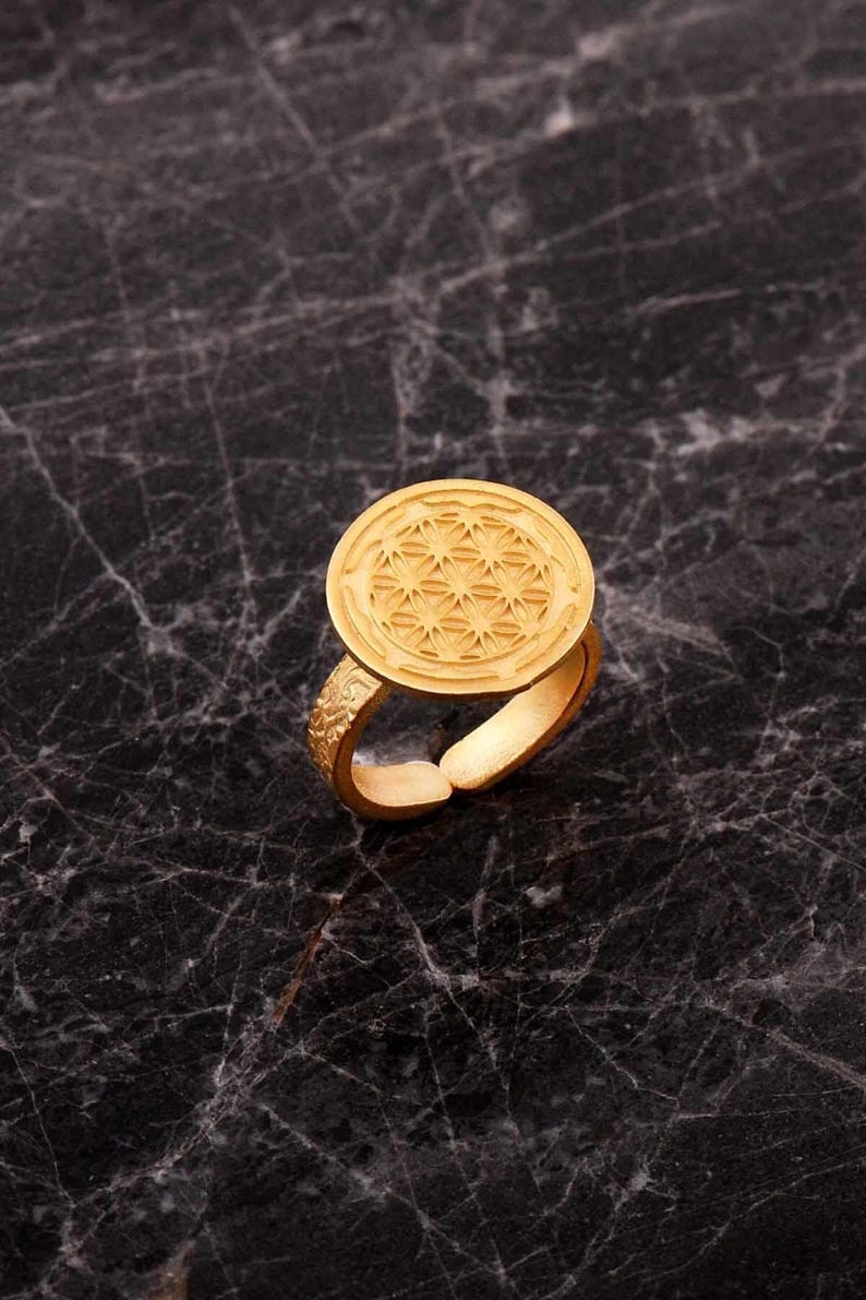 Handmade adjustable ring in 925 sterling silver with a green gold plated finish, featuring a detailed life flower motif on the band.