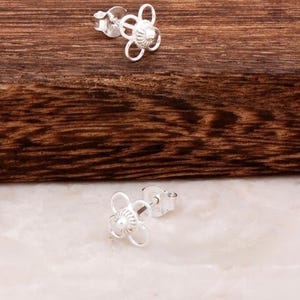 Handmade 925 sterling silver stud earrings featuring delicate filigree wirework in a small circular dot shape.