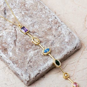 A handcrafted modern 925 sterling silver Y-shaped pendant necklace featuring a colorful vertical arrangement of geometric amethyst, jade, topaz, and zircon gemstones.