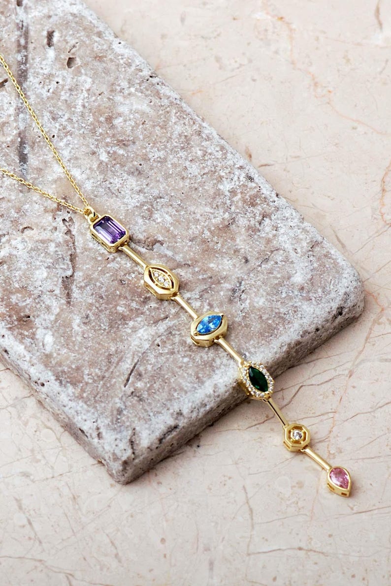 A handcrafted modern 925 sterling silver Y-shaped pendant necklace featuring a colorful vertical arrangement of geometric amethyst, jade, topaz, and zircon gemstones.