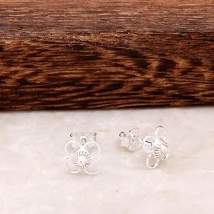 Handmade 925 sterling silver stud earrings featuring delicate filigree wirework in a small circular dot shape.