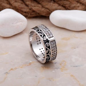 Handmade 7mm silver ring with white gold plating and sparkling cubic zirconia stones set in a delicate filigree design.