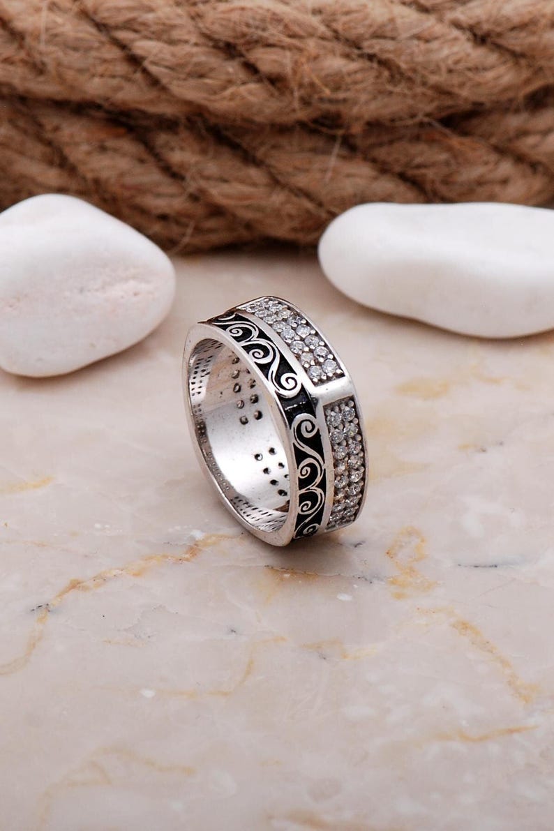 Handmade 7mm silver ring with white gold plating and sparkling cubic zirconia stones set in a delicate filigree design.
