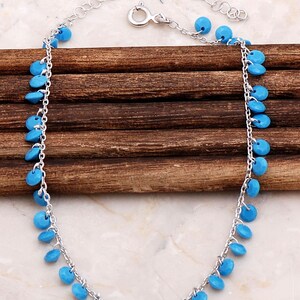 Handmade turquoise pendant chain made of 925 sterling silver with a gold‑plated rhodium finish, measuring 21.5 cm with 4.5 cm extenders.