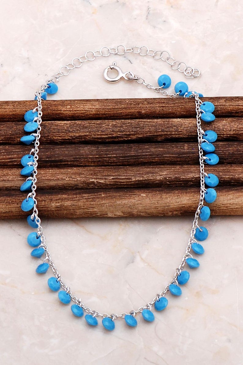 Handmade turquoise pendant chain made of 925 sterling silver with a gold‑plated rhodium finish, measuring 21.5 cm with 4.5 cm extenders.